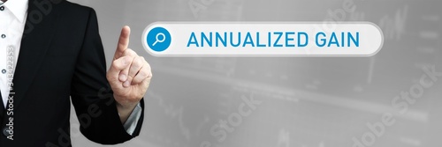 Annualized Gain. Man in a suit points a finger at a search box. The word Annualized Gain is in the search. Symbol for business, finance, statistics, analysis, economy photo