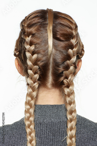 Obraz na plátně back view portrait of blonde female with creative braid hairdo.