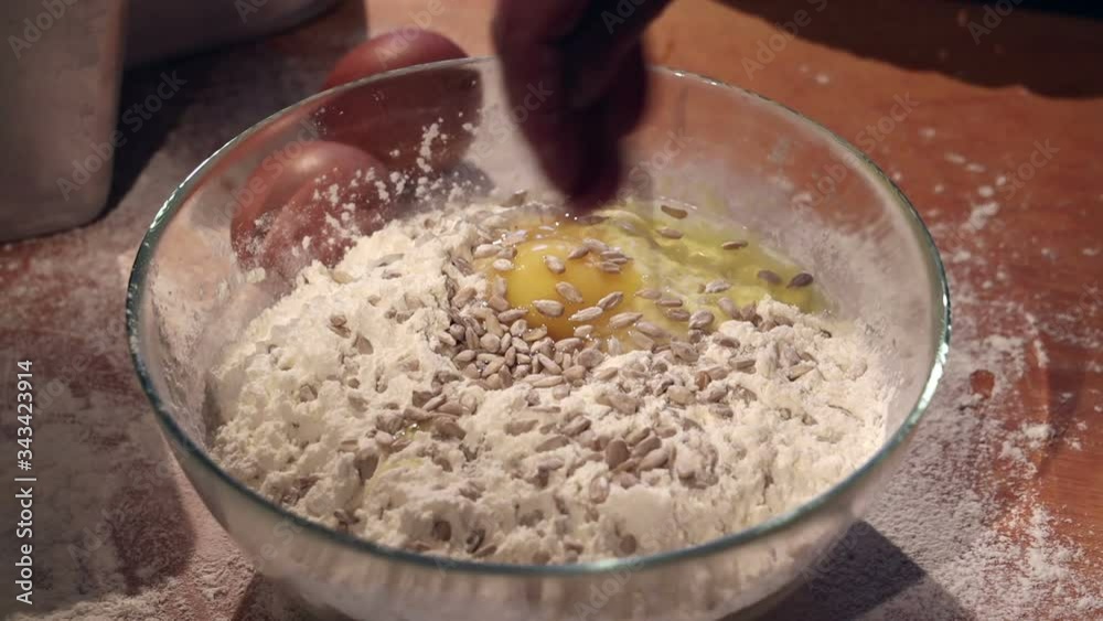 the hostess prepares a dough from flour eggs and sunflower seeds the hostess prepares a dough from flour eggs and sunflower seeds
