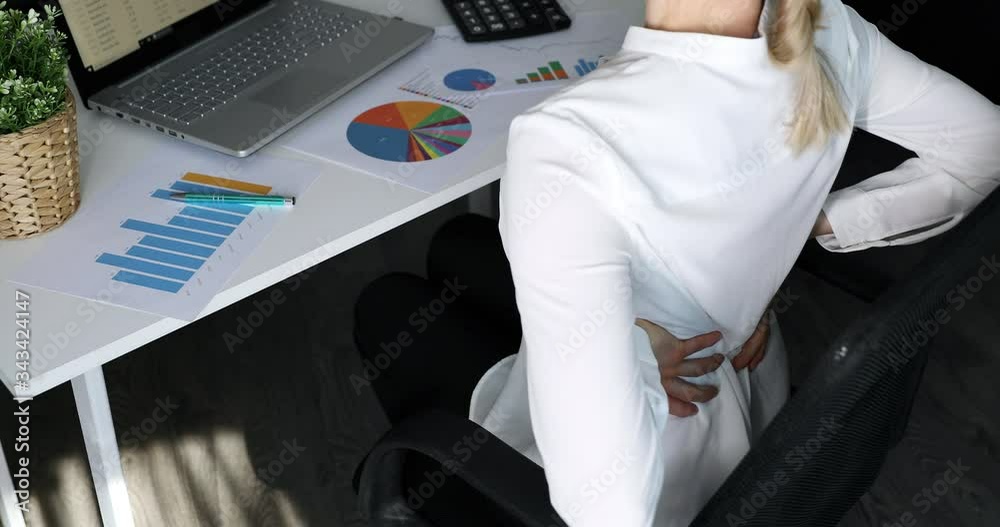 office syndrome - woman suffering from back pain while working with computer at work office syndrome - woman suffering from back pain while working with computer at work