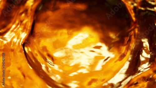 Super Slow Motion Shot of Rippling Golden Liquid at 1000fps. photo