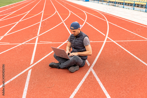 The guy with the laptop sits in the stadium, the programmer in the empty stadium. Working in unusual places