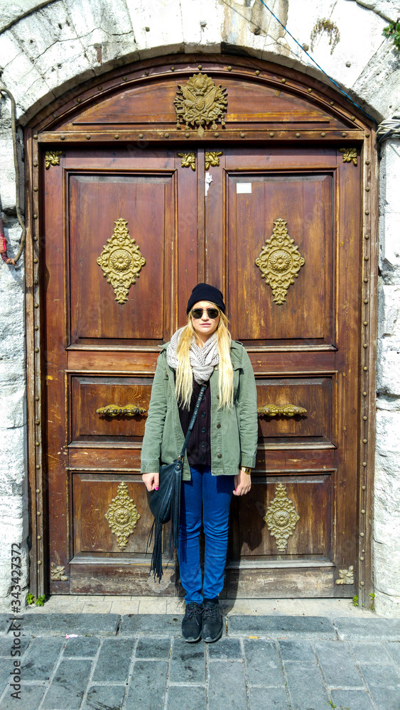 Caucasian woman standing in front of ornate door, Istanbul, Turkey