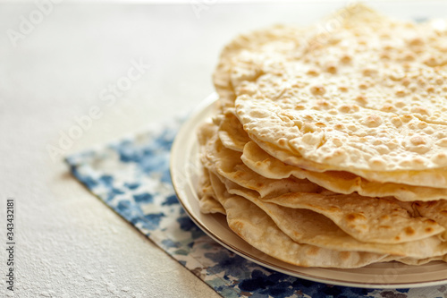 Stack of fresh homemade pita bread on plate. Copy space for text. photo