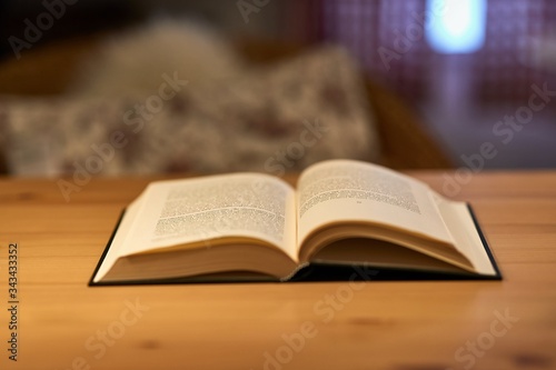 Open book on a table with shallow DoF