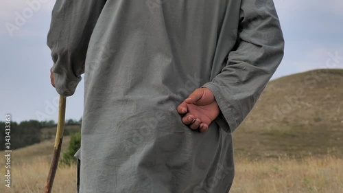 Behind. Mountains Of Afghanistan. Old Pashtun man walks through a desolate area photo