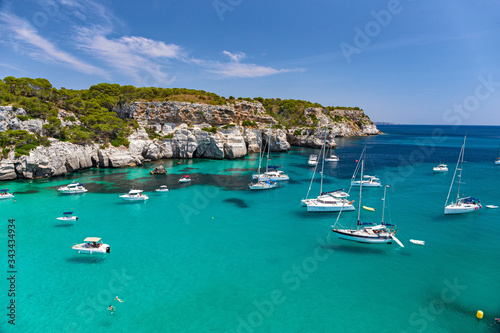 Panoramic view of the beautiful Macarella bay with many boats on the island of Menorca in Spain. photo