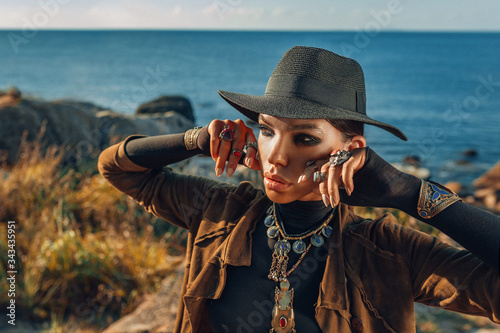 beautiful young fashionable woman outdoors at sunset