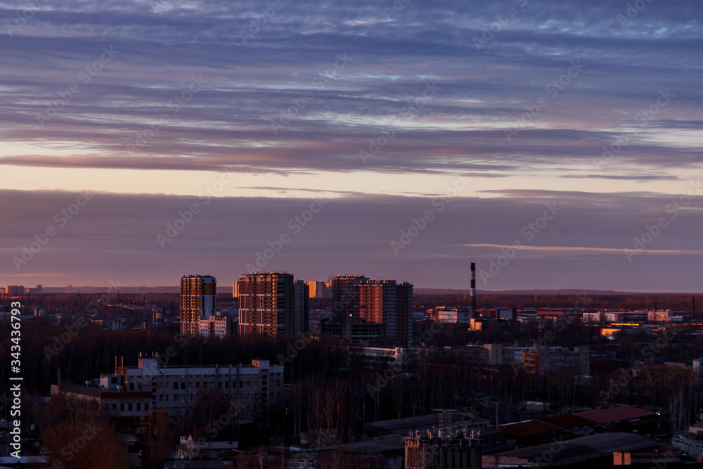 Aerial photography of the evening Industrial district of a large Russian city with warehouses, warehouses, offices and buildings. Beautiful sky at sunset.