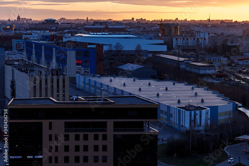 Aerial photography of the evening Industrial district of a large Russian city with warehouses, warehouses, offices and buildings. Beautiful sky at sunset.