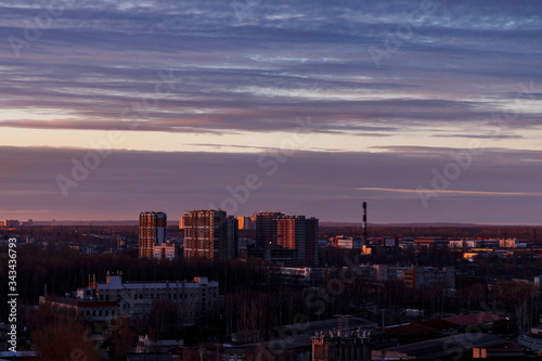 Aerial photography of the evening Industrial district of a large Russian city with warehouses, warehouses, offices and buildings. Beautiful sky at sunset.