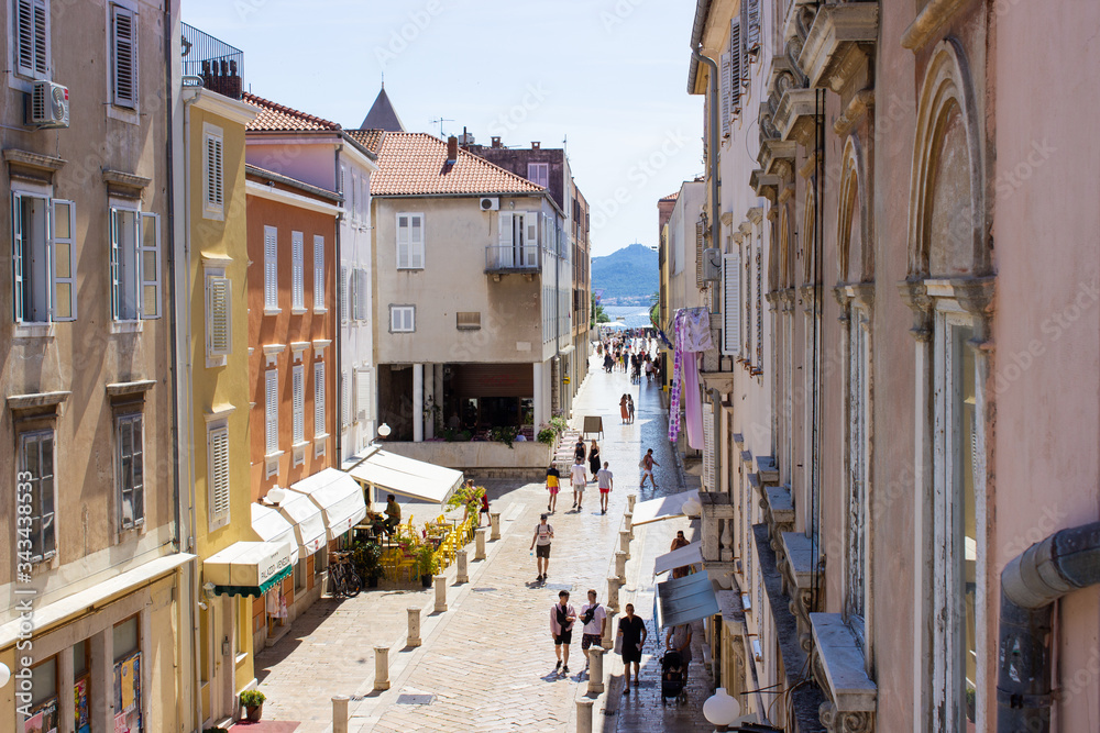 Fototapeta premium Typical croatian street with colorful buildings on both sides in the old town of Zadar, Croatia