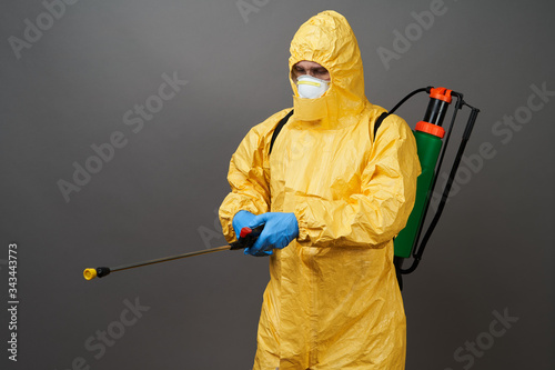 Coronavirus disinfection concept. Man in hazmat suit making disinfection