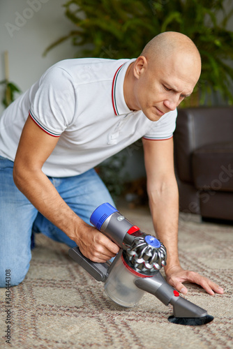 Man with vacuum cleaner at home.Home chores and routine concept