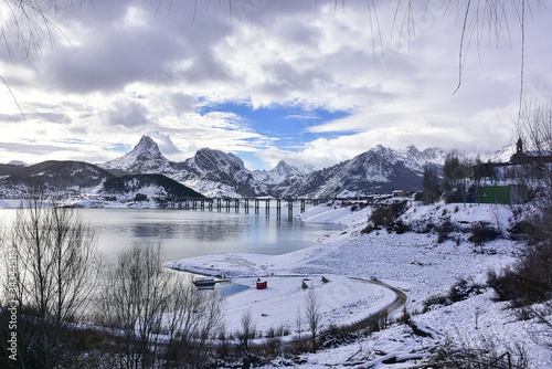 beautiful view of the snowy lake with mountains in the background