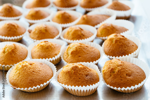 Homemade muffins on oven tray. Delicious pastries for dessert