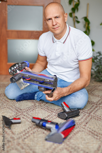 Man with vacuum cleaner at home.Home chores and routine concept
