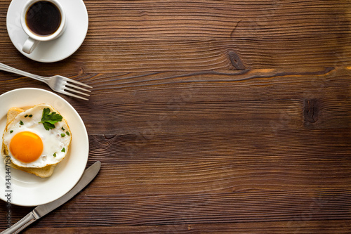 Fried eggs on toast on white table top view copy space