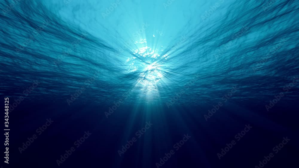 Underwater ocean waves deep blue ripple and flow with light rays. 4K seamless loop