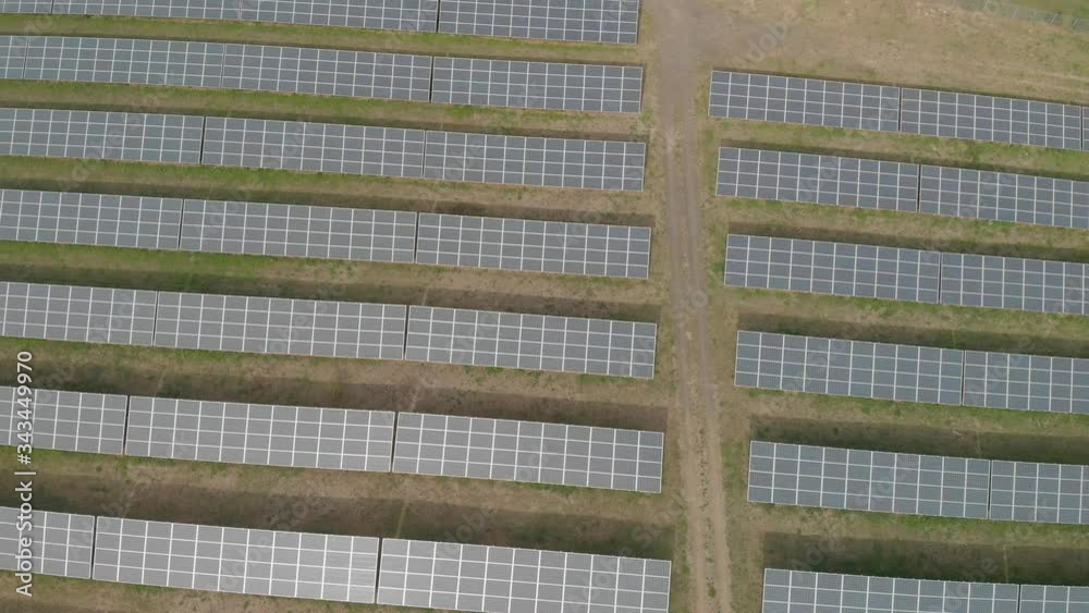 An ascending drone flight over an industrial solar power plant. A bird's eye view at renewable energies. An ascending drone flight over an industrial solar power plant. A bird's eye view at renewable energies.