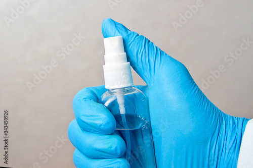 Sanitizer in a rubber glove. Disinfection of alcohol spray to prevent epidemic virus.