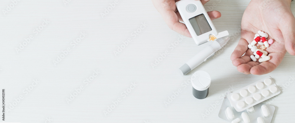person measures blood sugar with glucometer
