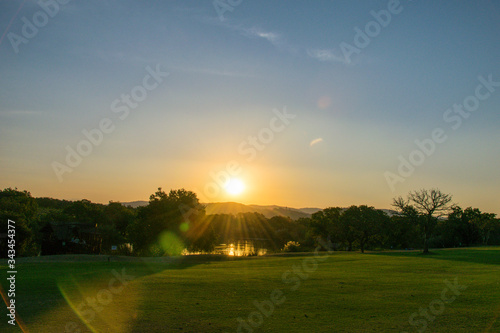 Golden sunset over green grass and water, Kruger National Park, South Africa