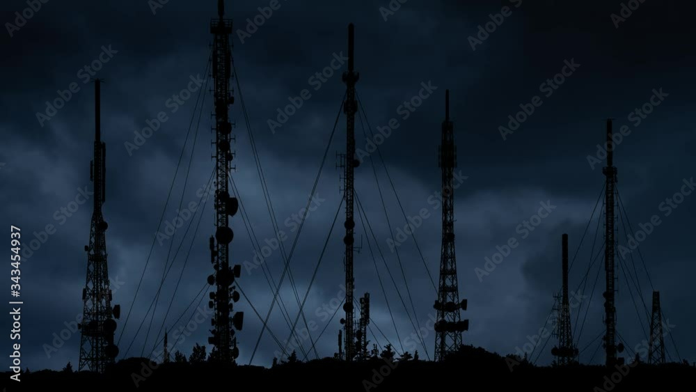 Telecommunication Towers With 4G, 5G and Television Antennas with Lightning and Thunderstorm in Background
