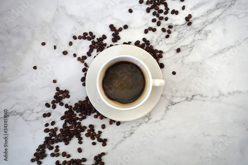 cup of coffee with beans, with marble background