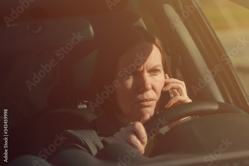 Businesswoman talking on mobile phone in the car