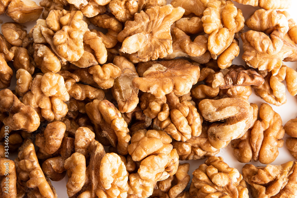 Lay flat Walnut dry fruits against a white background for a wall paper Lay flat Walnut dry fruits against a white background for a wall paper