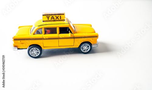 Yellow toy car taxi cab product shot in studio, isolated on white background. Transport, travel and transportation concept.