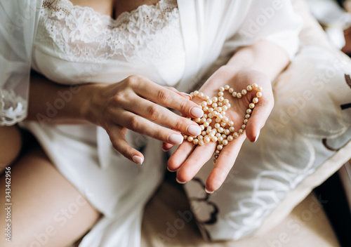 woman hands with pearl necklace