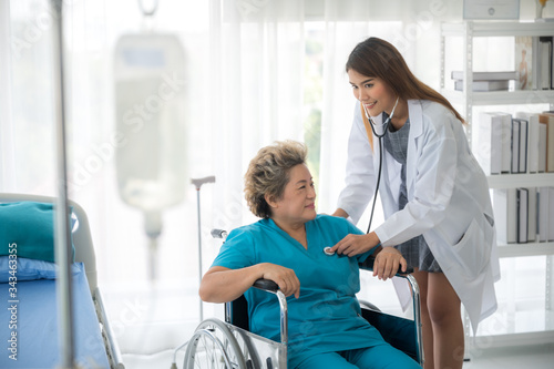 The doctor is checking the health of elderly patients in the hospital.