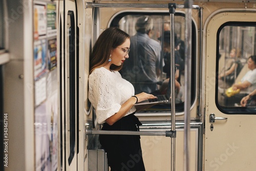 girl with laptop in subway