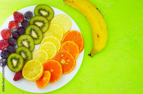 Fruit sliced ​​citrus fruits on a plate