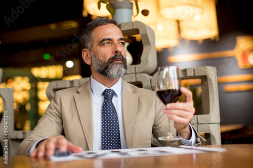 Handsome mature man drinkin...