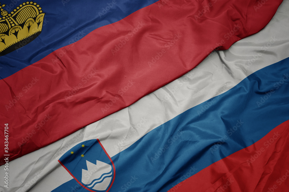 waving colorful flag of slovenia and national flag of liechtenstein. waving colorful flag of slovenia and national flag of liechtenstein.