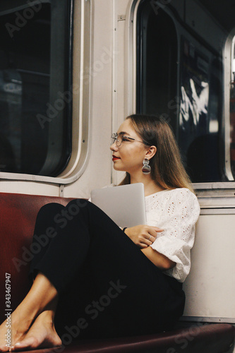 young woman sitting on a train