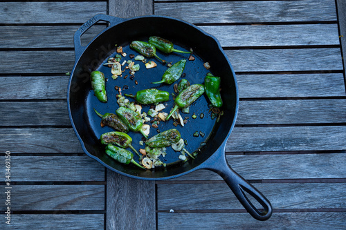 snack paprika with garlic and onions in a cast-iron pan as a delicious side dish for grilling