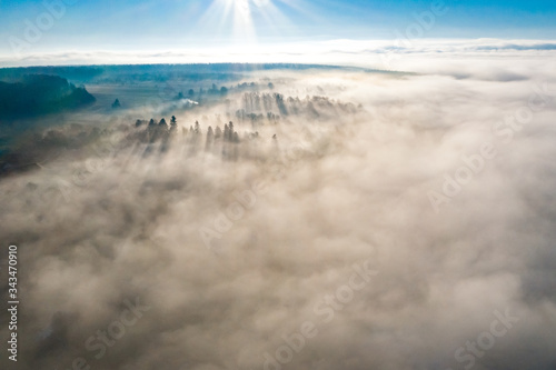Foggy winter morning in mountain village with top view © Niko_Dali