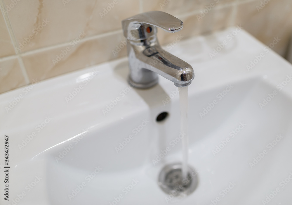 Closeup of faucet in modern bathroom. Selective focus with shallow depth of field. Closeup of faucet in modern bathroom. Selective focus with shallow depth of field.