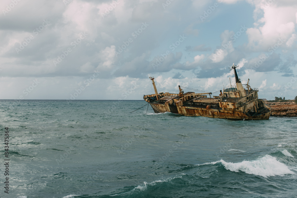 rusty ship in blue water of mediterranean sea
