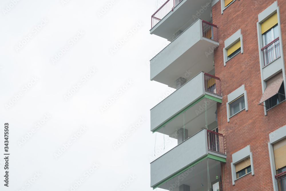 Balconies of a residential building on the right. White copy space on the left Balconies of a residential building on the right. White copy space on the left