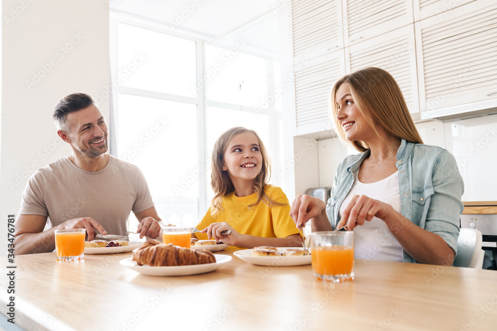 Photo of happy family smiling and talking while having breakfast Photo of happy family smiling and talking while having breakfast