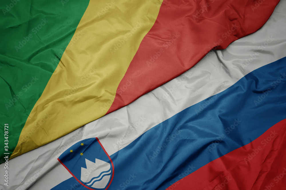 waving colorful flag of slovenia and national flag of republic of the congo.