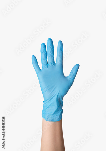 Coronavirus protection. Female doctor showing hand in rubber glove on white background, isolated. Closeup view