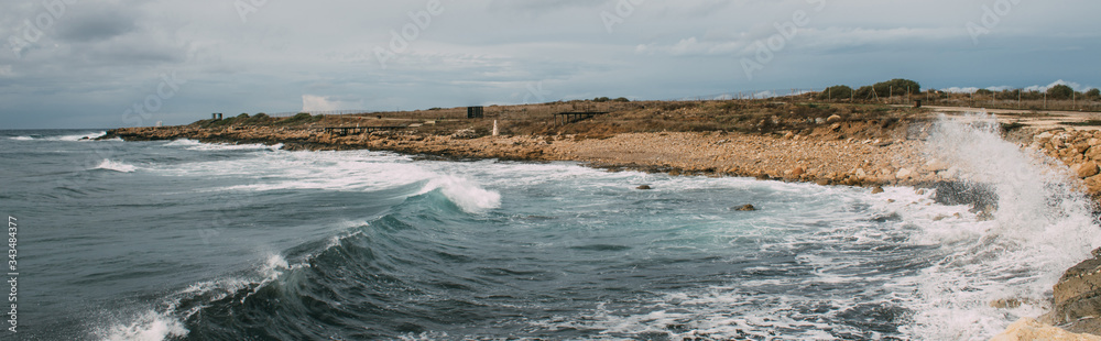 panoramic shot of coastline with stones near mediterranean sea