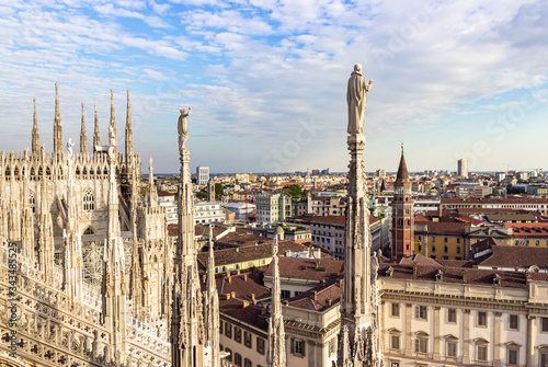 View from the decorated stone carvings of the Cathedral of Milan - Duomo di Milano roof in Milan city, Italy © svarshik