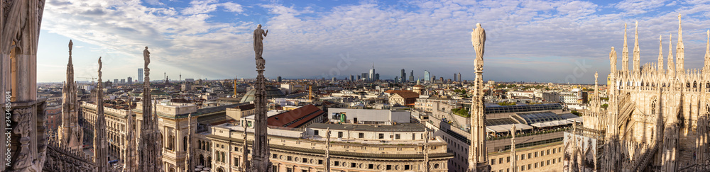 Panoramic view from the decorated stone carvings of the Cathedral of Milan - Duomo di Milano roof in Milan city, Italy